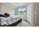 Cozy bedroom with carpeted floors, a double bed and window with view of the trees at 11481 King St, Westminster, CO 80031