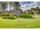 Stone monument with manicured lawn and flowerbeds welcomes residents to the community at 11481 King St, Westminster, CO 80031