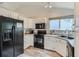 Bright kitchen showcasing modern appliances, white cabinetry, and great natural light at 11481 King St, Westminster, CO 80031
