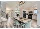 Open-concept living room connecting to kitchen and dining area with natural light at 11481 King St, Westminster, CO 80031