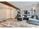 Spacious living room with a large grey sectional sofa, fireplace, and an open staircase to the second floor at 11481 King St, Westminster, CO 80031