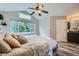 Well-lit bedroom boasts a large window offering views of trees and vaulted ceilings at 11481 King St, Westminster, CO 80031