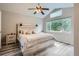 Comfortable bedroom featuring wood floors, a large window, and a stylish white-washed headboard at 11481 King St, Westminster, CO 80031