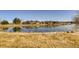 Community pond with a walking path provides an outdoor space for neighborhood residents at 11481 King St, Westminster, CO 80031