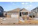 Ranch-style home with a neutral exterior, stone accents, and a two-car garage at 39 N Waterloo St, Aurora, CO 80018