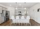 Kitchen island with seating for four and granite countertops at 39 N Waterloo St, Aurora, CO 80018