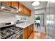 Kitchen featuring stainless steel stove, wood cabinets and hardwood floor at 9177 W Cedar Dr # D, Lakewood, CO 80226