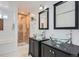 Modern bathroom features double vanity with glass bowl sinks and tiled walk-in shower at 2280 W Center Ave, Denver, CO 80223