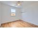 Bedroom with hardwood floors, a window, and modern light fixture at 2280 W Center Ave, Denver, CO 80223