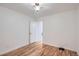 Simple bedroom with hardwood floors and a view to the next room at 2280 W Center Ave, Denver, CO 80223