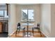 Cozy breakfast nook with round table and seating by a bright window at 2280 W Center Ave, Denver, CO 80223