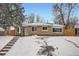 Charming brick home with snow covered front yard at 2280 W Center Ave, Denver, CO 80223