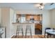 Open kitchen view showcases wood cabinets, stainless appliances, and bar seating at 2280 W Center Ave, Denver, CO 80223