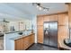 Kitchen featuring stainless steel refrigerator and wood cabinets at 2280 W Center Ave, Denver, CO 80223