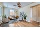 Inviting living room with hardwood floors, ceiling fan, and ample natural light at 2280 W Center Ave, Denver, CO 80223