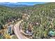 Scenic aerial view of property surrounded by lush greenery and majestic mountains at 27389 Highway 74, Evergreen, CO 80439