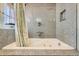 Close-up of a deep jacuzzi tub with elegant gray tile surround, perfect for relaxation and comfort at 27389 Highway 74, Evergreen, CO 80439