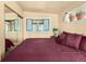 Comfortable bedroom with a large mirror and a window with flower pots, creating a cozy atmosphere at 27389 Highway 74, Evergreen, CO 80439