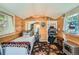 Inviting bedroom featuring a single bed, wooden walls, and decor elements for a cozy cabin feel at 27389 Highway 74, Evergreen, CO 80439