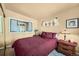 Bright bedroom with a window displaying plants, alongside a classic lamp sitting on a small bedside table at 27389 Highway 74, Evergreen, CO 80439