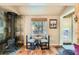 Charming dining nook with a cozy table, two chairs, a wood-burning stove, and natural light at 27389 Highway 74, Evergreen, CO 80439