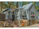 Charming gray home featuring stone accents, brick stairs, and flower boxes under the windows at 27389 Highway 74, Evergreen, CO 80439