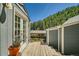 Charming backyard deck with wood and gray trim against a forested backdrop at 27389 Highway 74, Evergreen, CO 80439