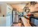 Functional kitchen with stainless steel appliances, wooden cabinets, and ample counter space at 27389 Highway 74, Evergreen, CO 80439