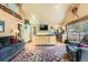 Spacious open concept living area with a kitchen island, comfortable seating, and vaulted ceilings at 27389 Highway 74, Evergreen, CO 80439