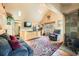 Cozy living room with vaulted ceilings, hardwood floors, fireplace, and comfortable seating area at 27389 Highway 74, Evergreen, CO 80439