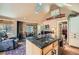 Open-concept living room featuring a kitchen island, vaulted ceiling, and comfortable seating area at 27389 Highway 74, Evergreen, CO 80439