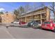 Exterior view of property with parking spaces and mature trees at 3423 Madison Ave # X133, Boulder, CO 80303