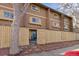 Rear exterior view of property with a private patio featuring a secure wooden fence at 3423 Madison Ave # X133, Boulder, CO 80303