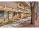 Charming condo building featuring a trellised walkway and vibrant red doors at 3423 Madison Ave # X133, Boulder, CO 80303