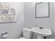 Bright powder room with a pedestal sink, modern mirror, and tasteful decor at 3423 Madison Ave # X133, Boulder, CO 80303