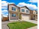 Two-story house with beige siding, gray shutters, and a two-car garage at 2236 Crosswind St, Fort Lupton, CO 80621