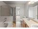 Bright bathroom with a tub-shower combo, double vanity and tile floors at 619 S Norfolk Way, Aurora, CO 80017