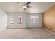 Spacious bedroom with a ceiling fan and three large windows at 619 S Norfolk Way, Aurora, CO 80017