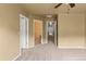 Bedroom with views into the hallway and bathroom featuring neutral walls and carpeted floors at 619 S Norfolk Way, Aurora, CO 80017