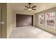 Bedroom featuring a ceiling fan, neutral walls, carpeted floor and a brown accent wall at 619 S Norfolk Way, Aurora, CO 80017