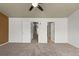 Carpeted bedroom with doors to hallway and ensuite bathroom at 619 S Norfolk Way, Aurora, CO 80017
