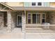 Home's stone-accented porch with door and windows, showing natural light and charming details at 619 S Norfolk Way, Aurora, CO 80017