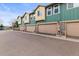 Townhome with attached garages with stone and painted siding and close to street with stop sign at 619 S Norfolk Way, Aurora, CO 80017