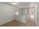 Upstairs hallway with carpeted floor and a view to the spare bedroom at 619 S Norfolk Way, Aurora, CO 80017