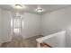 Bright, carpeted hallway leading to bedrooms with clean white walls at 619 S Norfolk Way, Aurora, CO 80017