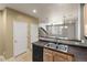A cozy kitchen features stainless steel sink, neutral countertops, and a black dishwasher at 619 S Norfolk Way, Aurora, CO 80017