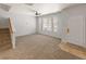 Bright living room featuring plush carpet, large windows and neutral paint at 619 S Norfolk Way, Aurora, CO 80017