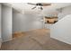 Open living area with plush carpet that transitions into the kitchen space at 619 S Norfolk Way, Aurora, CO 80017