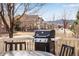 Backyard view features grill, table and chairs, houses, trees, and scenic mountain view at 16022 W 63Rd Ln # A, Arvada, CO 80403