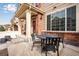 Charming front porch with table and chairs offers a welcoming outdoor space at 16022 W 63Rd Ln # A, Arvada, CO 80403